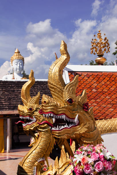 istock Beautiful Naga statue and Buddha statue backgroundat Wat Doi Kham 1069420948