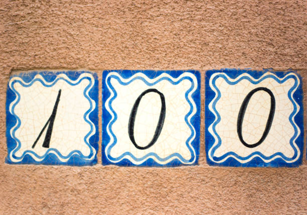 istock Ceramic Number 100 Street Address Tiles; Brown Wall 1069421600