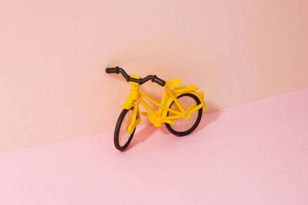 istock Yellow bike model, Pink Two Tone Background 1069422858