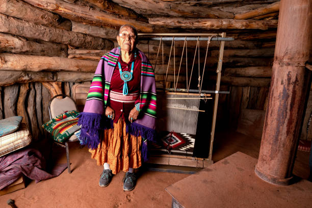 istock Beautiful Eighty Five Year Old Senior Native American Navajo Woman Posing Inside an Authentic Hogan with weaving loom 1069425602
