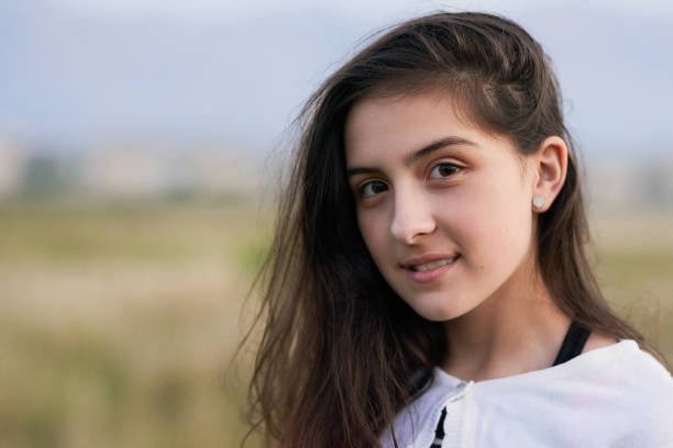 Portrait of a teenage girl standing outside