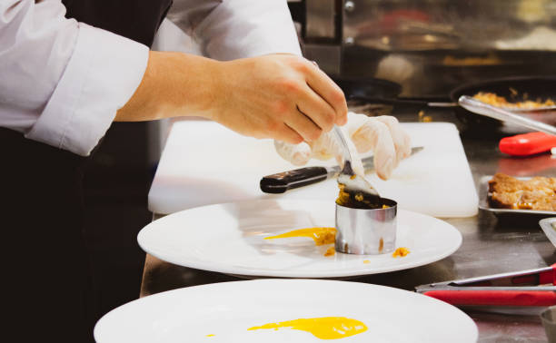 istock Chef preparing food, meal, in the kitchen, chef cooking, Chef decorating dish, closeup, Chef preparing food, meal, in the kitchen, chef cooking, Chef decorating dish, closeup, 1069442240