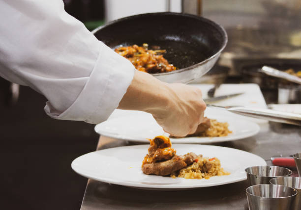 istock Chef preparing food, meal, in the kitchen, chef cooking, Chef decorating dish, closeup, Chef preparing food, meal, in the kitchen, chef cooking, Chef decorating dish, closeup, 1069442260