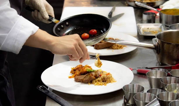istock Chef preparing food, meal, in the kitchen, chef cooking, Chef decorating dish, closeup, Chef preparing food, meal, in the kitchen, chef cooking, Chef decorating dish, closeup, 1069442286