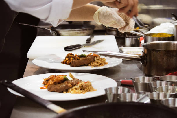 istock Chef preparing food, meal, in the kitchen, chef cooking, Chef decorating dish, closeup, Chef preparing food, meal, in the kitchen, chef cooking, Chef decorating dish, closeup, 1069442294