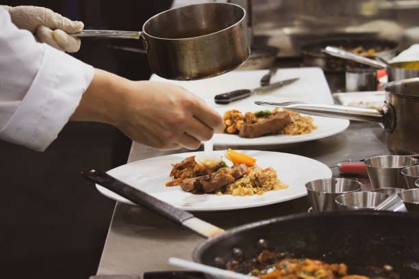 istock Chef preparing food, meal, in the kitchen, chef cooking, Chef decorating dish, closeup, Chef preparing food, meal, in the kitchen, chef cooking, Chef decorating dish, closeup, 1069442298