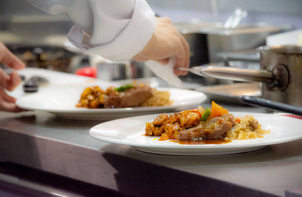 istock Chef preparing food, meal, in the kitchen, chef cooking, Chef decorating dish, closeup, Chef preparing food, meal, in the kitchen, chef cooking, Chef decorating dish, closeup, 1069442332