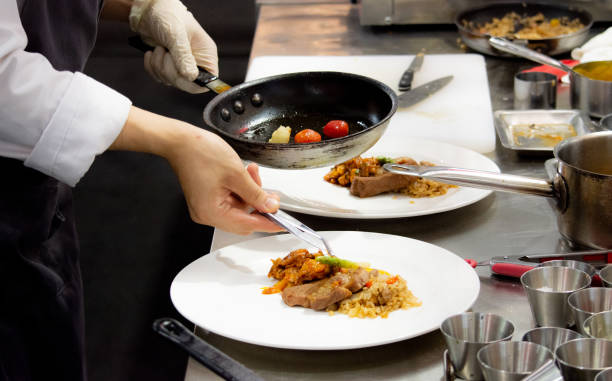 istock Chef preparing food, meal, in the kitchen, chef cooking, Chef decorating dish, closeup, Chef preparing food, meal, in the kitchen, chef cooking, Chef decorating dish, closeup, 1069442344
