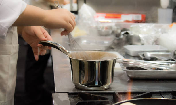 istock Chef preparing food, meal, in the kitchen, chef cooking, Chef decorating dish, closeup, Chef preparing food, meal, in the kitchen, chef cooking, Chef decorating dish, closeup, 1069442384
