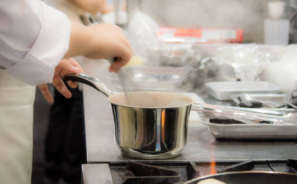 istock Chef preparing food, meal, in the kitchen, chef cooking, Chef decorating dish, closeup, 
Chef preparing food, meal, in the kitchen, chef cooking, Chef decorating dish, closeup, 1069442408