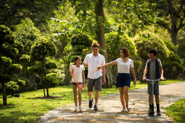istock Modern Asian family in the park 1069444090