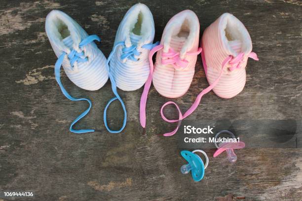 2019 New Year Written Laces Of Childrens Shoes And Pacifier On Old Wooden Background Top View Flat Lay Stock Photo - Download Image Now