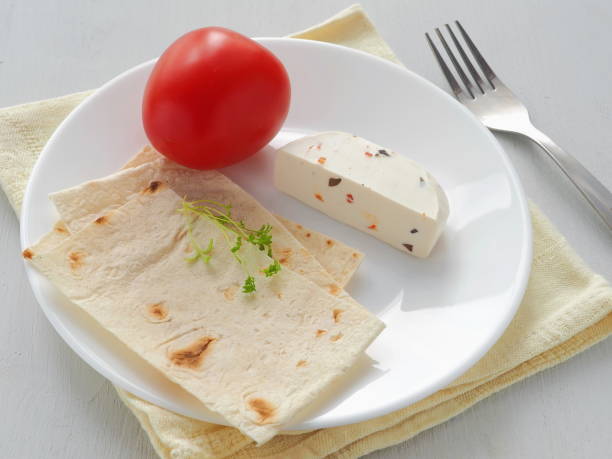 High view of vegetarian breakfast with soft cheese, vegetables and grocery served with fresh pita bread. Healthy breakfast. stock photo
