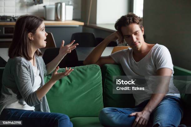Young Couple Talking About Their Relations At Home Stock Photo - Download Image Now - Couple - Relationship, Discussion, Frustration