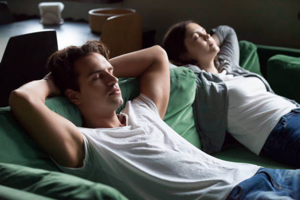 istock Young couple sitting and couch and relaxing 1069463212