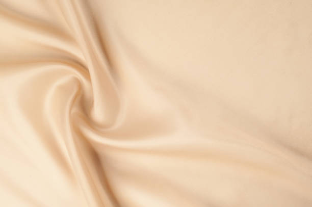 istock Texture background of fabric. Beige fabric. Silk fabric wallpaper texture background pattern in sepia pastel yellow cream beige tint: Lovely natural silk textured textile 1069466642