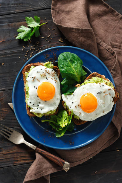 istock Healthy breakfast top view avocado toasts fried eggs 1069466688