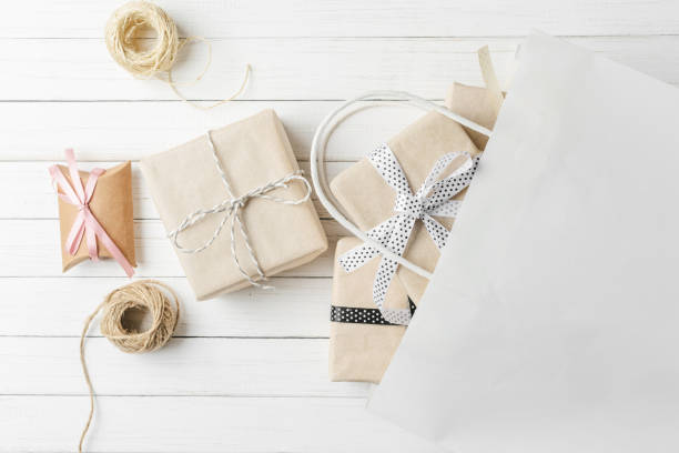istock Gift boxes with decorations and paper bag on a white background, top view 1069468712
