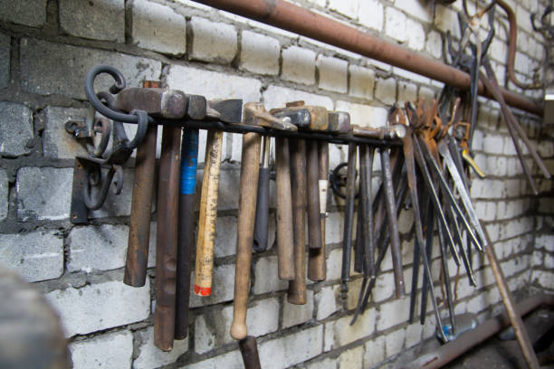 istock Workspace of blacksmith. Some tools on the wall. view at an angle 1069469038