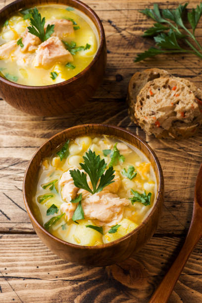 istock Fish soup in a wooden bowl with fresh herbs. 1069469624