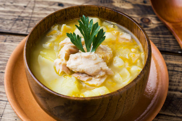 istock Fish soup in a wooden bowl with fresh herbs. 1069469638