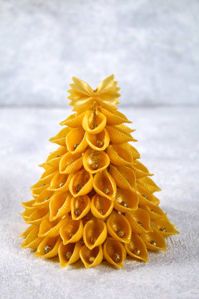 How to make a Christmas tree from raw pasta conchiglie. The process of making Christmas trees from pasta, cardboard plates, hot glue and paint or spray. Guide, step by step on the photo.Handmade, DIY.