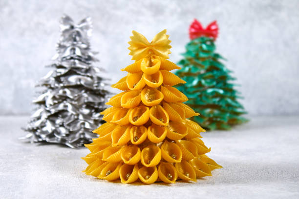 istock How to make a Christmas tree from raw pasta conchiglie. The process of making Christmas trees from pasta, cardboard plates, hot glue and paint or spray. Guide, step by step on the photo.Handmade, DIY. 1069470978