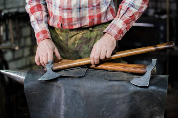 istock Concept of new axes lies on leather at forge. Blacksmith at work 1069471230