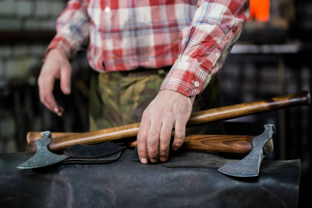 istock Concept of new axes lies on leather apron. Blacksmith at work 1069471270