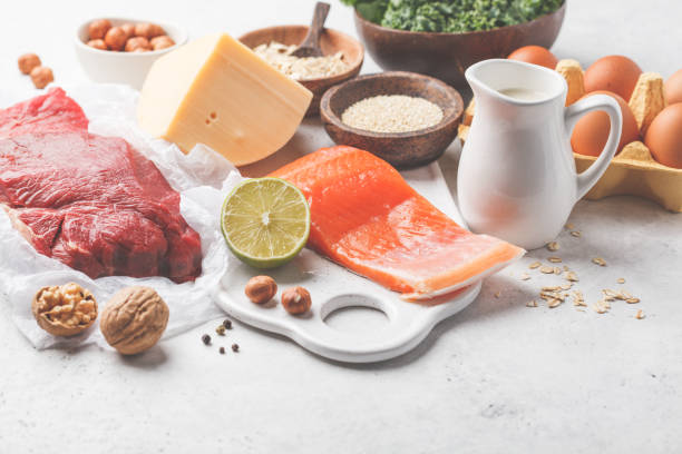 istock Balanced diet food background. Protein foods: fish, meat, cheese, quinoa, nuts on white background. 1069471502