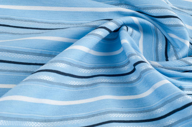 istock Texture, background, pattern. Woolen fabric is blue, striped. Outdoor family travel and vacation wallpaper with a checkered pattern pattern. Blue and white fabric fabric lines. 1069471908