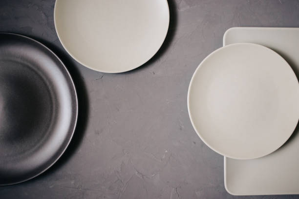 istock Top view of set ceramic dishes brown and milky white colored, on gray background 1069472002