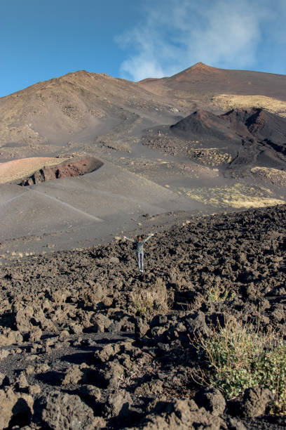 istock Woman walking over volcanic landscape 1069473948