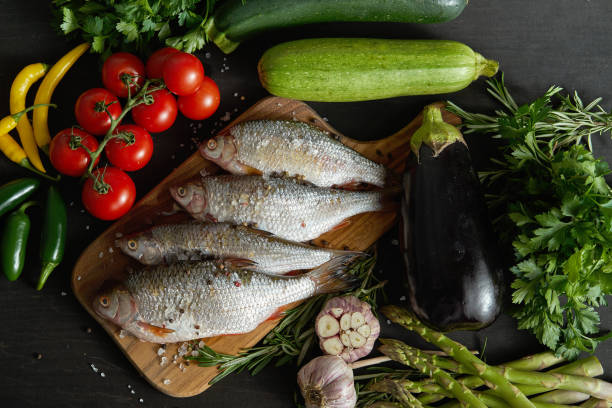 istock top view offresh raw dorada fish on a wooden board with a set of vegetables on a black table 1069474334