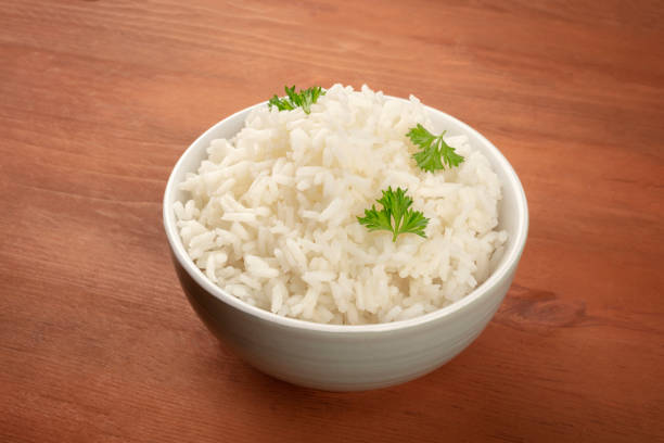 istock A bowl of cooked white long grain rice on a dark rustic wooden background with copy space 1069475478