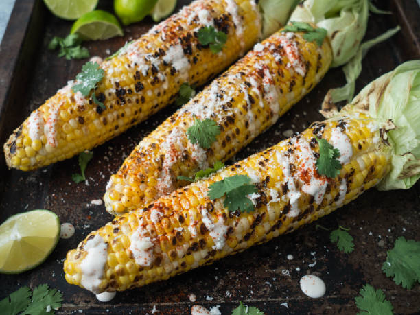 istock Grilled corn cobs with sauce, coriander, lime, paprika and cheese. 1069476346