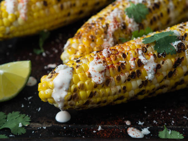 istock Grilled corn cobs with sauce, coriander, lime, paprika and cheese. 1069476348