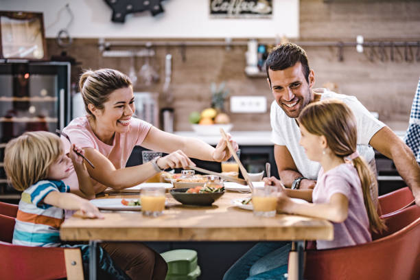 istock Happy family talking during lunch at dining table. 1069476356
