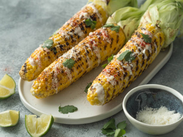 istock Grilled corn cobs with sauce, coriander, lime, paprika and cheese. 1069476368