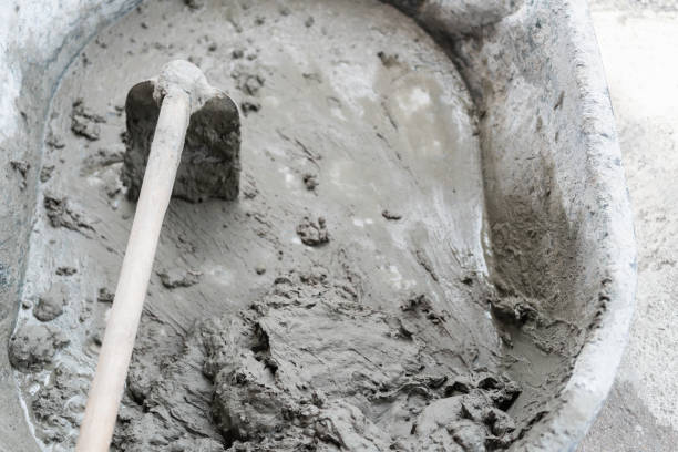 istock Mixed concrete mortar in black plastic bucket cement mixer for construction. 1069478636
