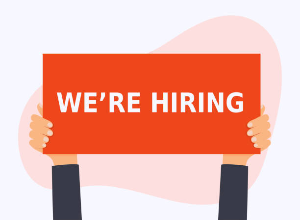 istock Hand holding the WE'RE HIRING banner. Business hiring and recruiting concept. 1069479554