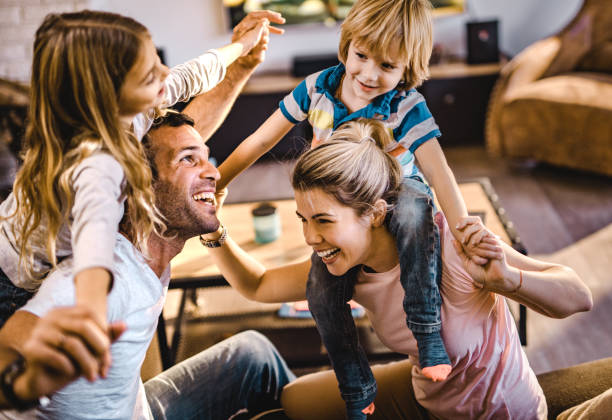 istock Playful parents having fun with their kids at home. 1069481230