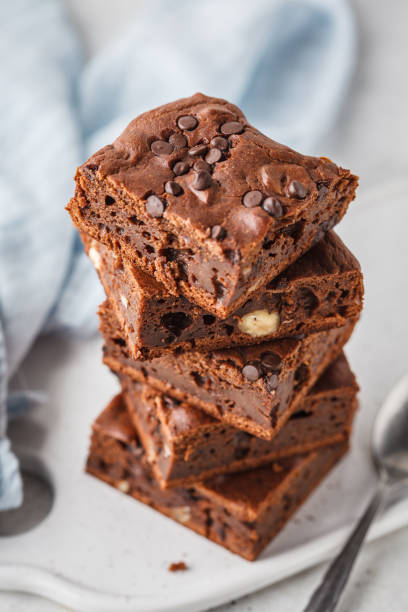 istock Stack pieces of chocolate vegan cake with chocolate drops and nuts. 1069482258