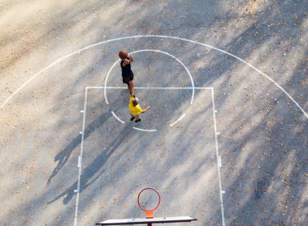 istock Father and son playing basketball in the park 1069482442
