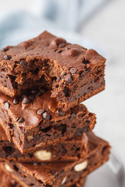 istock Stack pieces of chocolate vegan cake with chocolate drops and nuts. 1069482546