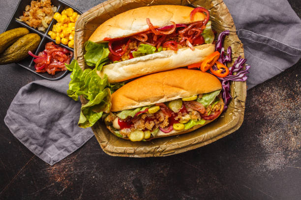 istock Hot dogs with assorted toppings on a dark background, top view. 1069485166