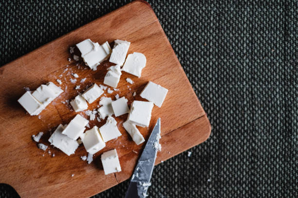 istock Top view of goat cheese on wooden cutting board 1069487668