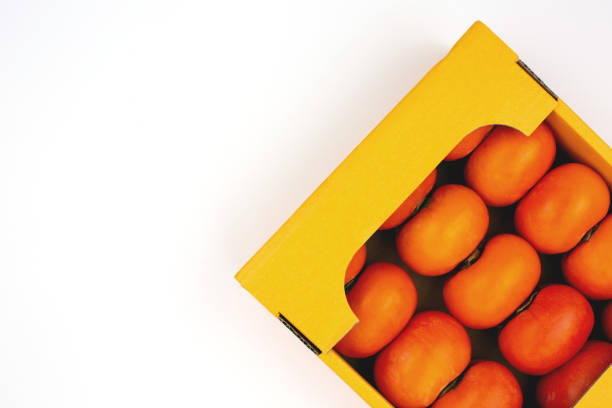 This is a close up photograph of orange citrus fruit from Spain on retail display at an outdoor farmer’s market in Paris, France.