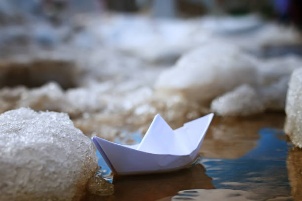 istock tinted photo paper boat on spring street 1069500194