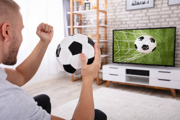 istock Man Watching Football Match On Television 1069502708